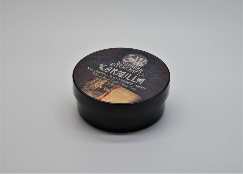 Carmilla is tribute to one of the first ever vampire stories: the scent of a cloying and seductive temptress centered around Nag Champa, Amber, Sandalwood, and Frankincense. Notes: Nag champa, amber, sandalwood, frankincense, bitter citrus, vanilla, honeysuckle, oakmoss Ingredients: Water, stearic acid, shea butter, castor oil, potassium hydroxide, glycerine, coconut oil, sodium lactate, sodium hydroxide, jojoba oil, aloe powder, liquid aloe, isopropyl myristate, kaolin clay, fragrance Net Weight 115g.